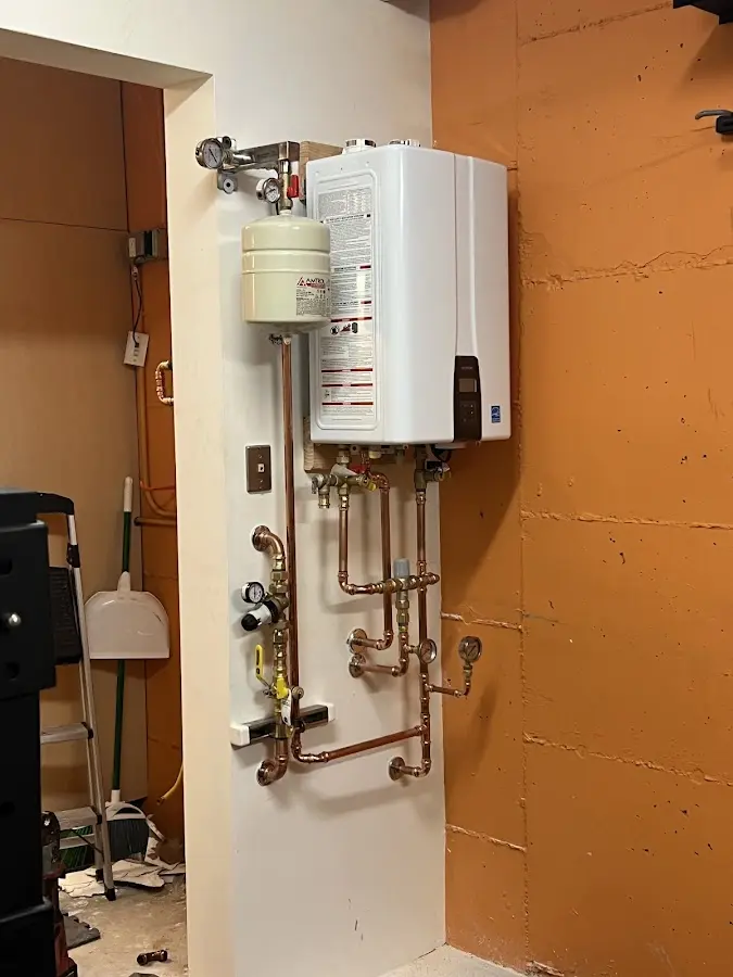 Plumbing technician inspecting water heater connections in North Miami
